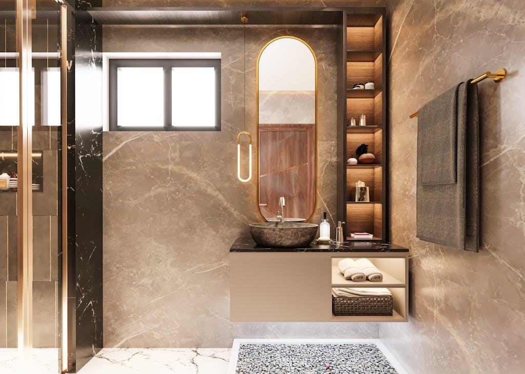 Elegant bathroom featuring marble finish, oval mirror, and stylish lighting. Ideal for modern interior design inspiration.